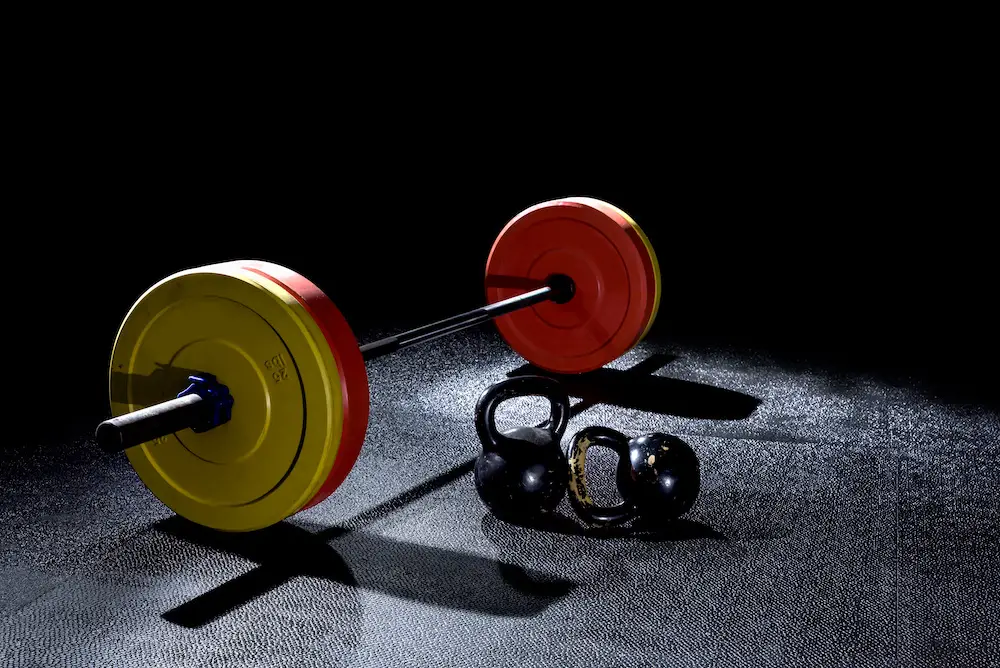 Bumper plates in gym with dramatic lighting